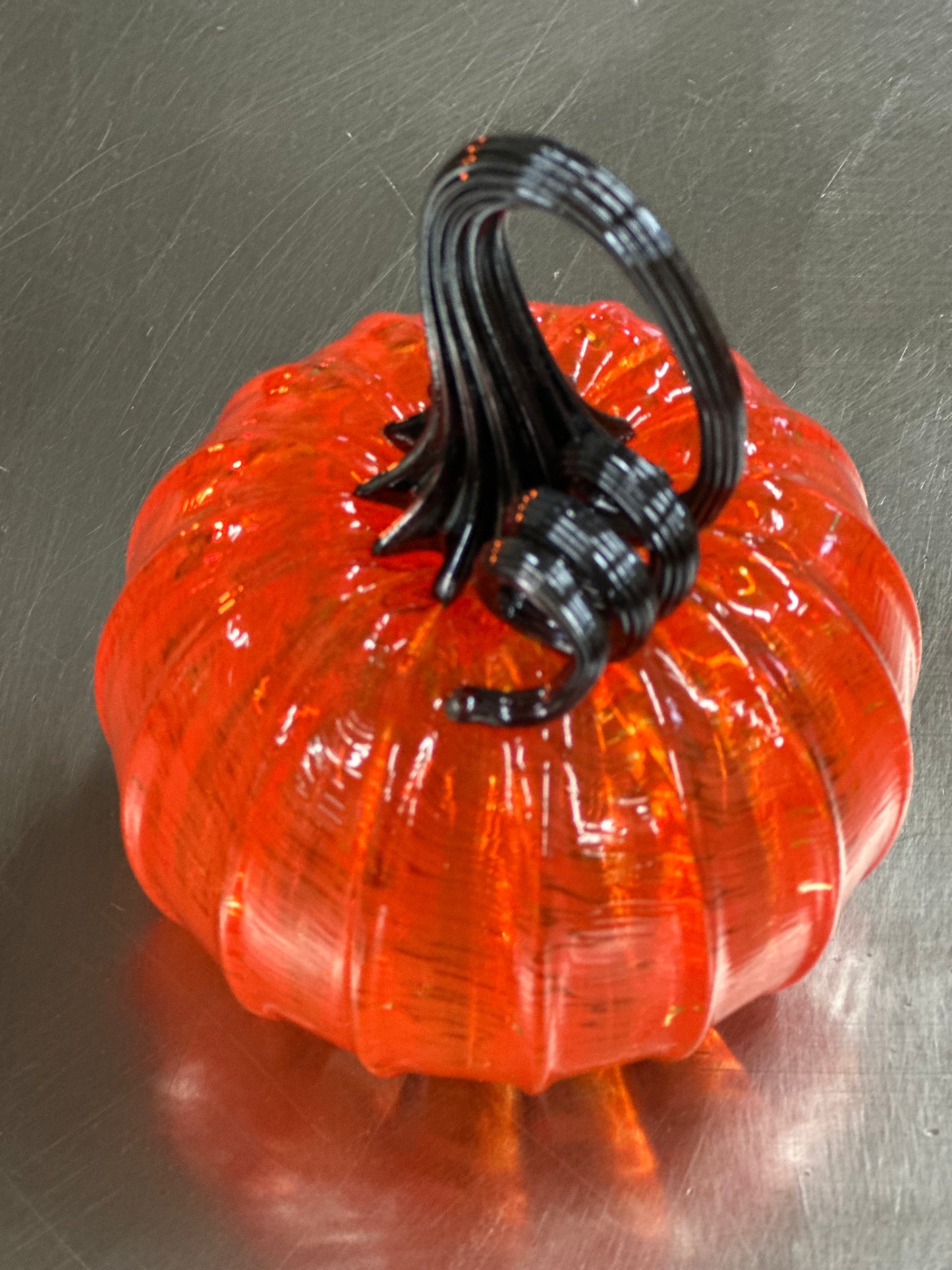 103 Orange and black glass pumpkin.