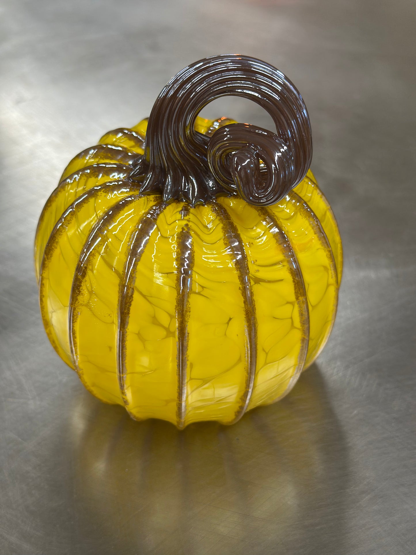105 Yellow and brown glass pumpkin.