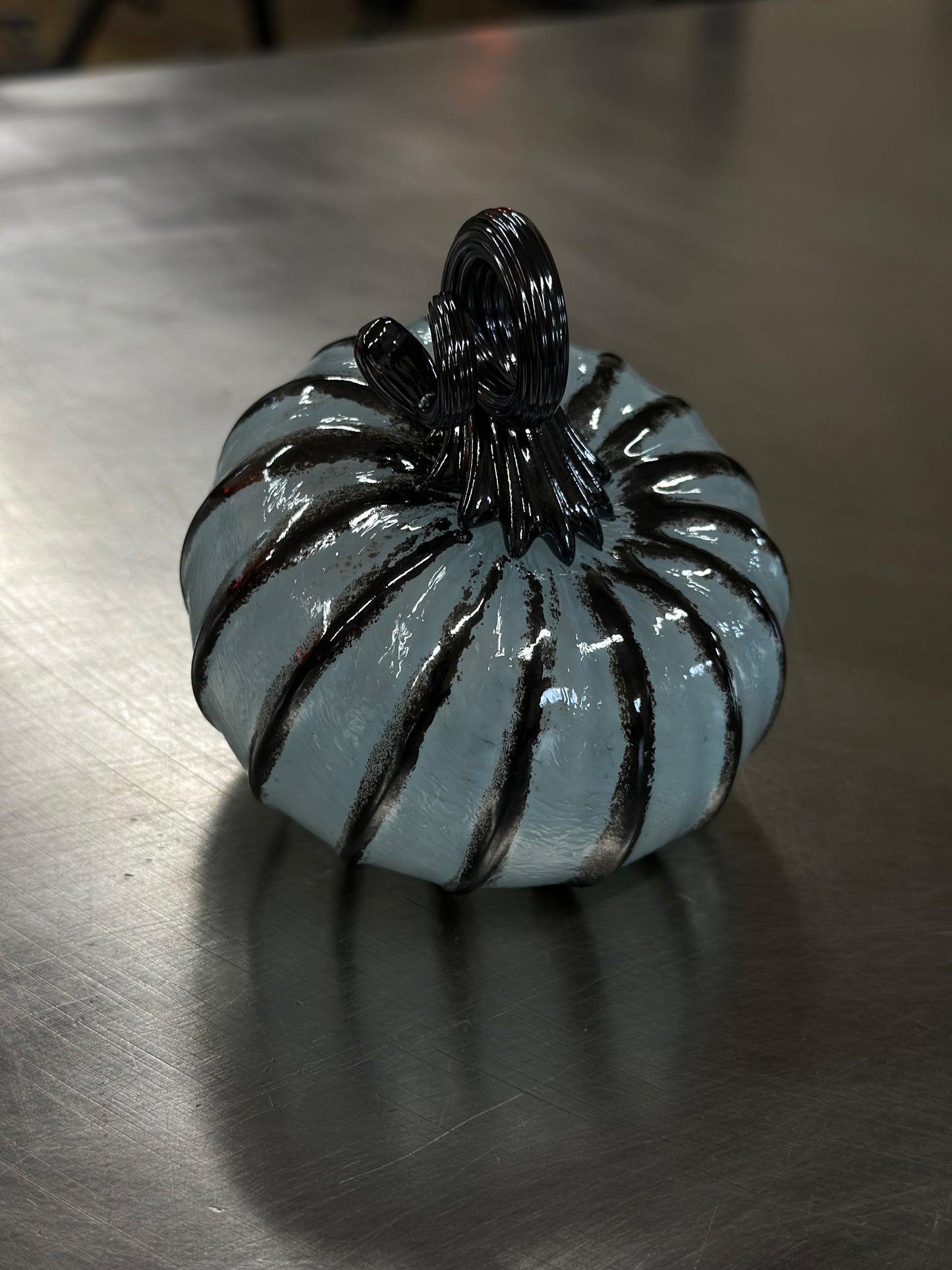 110 Baby blue and black glass pumpkin.