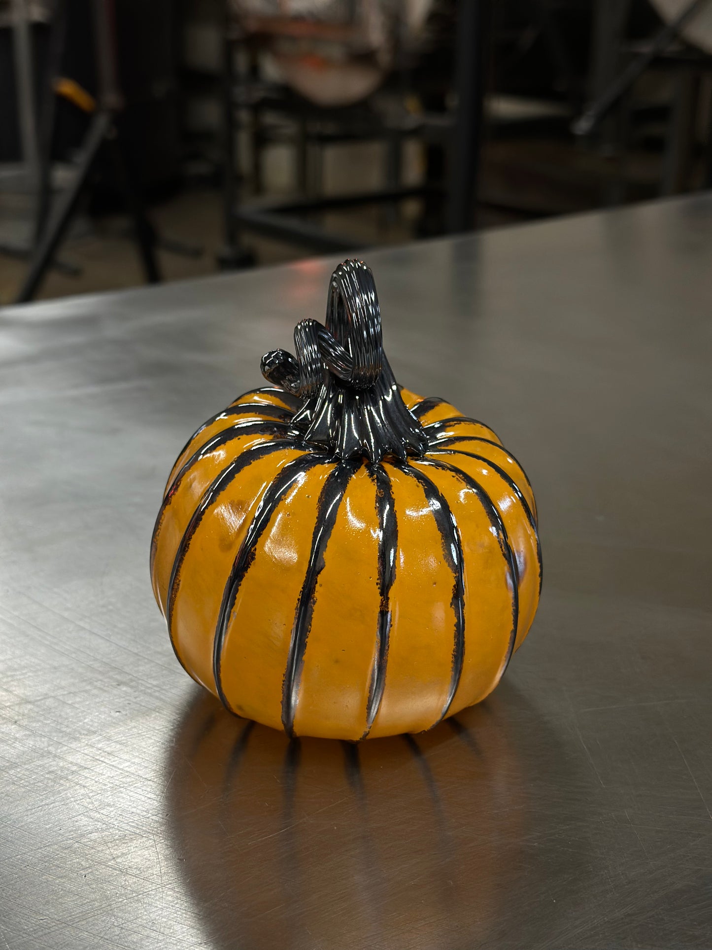 111 Orange and black glass pumpkin.