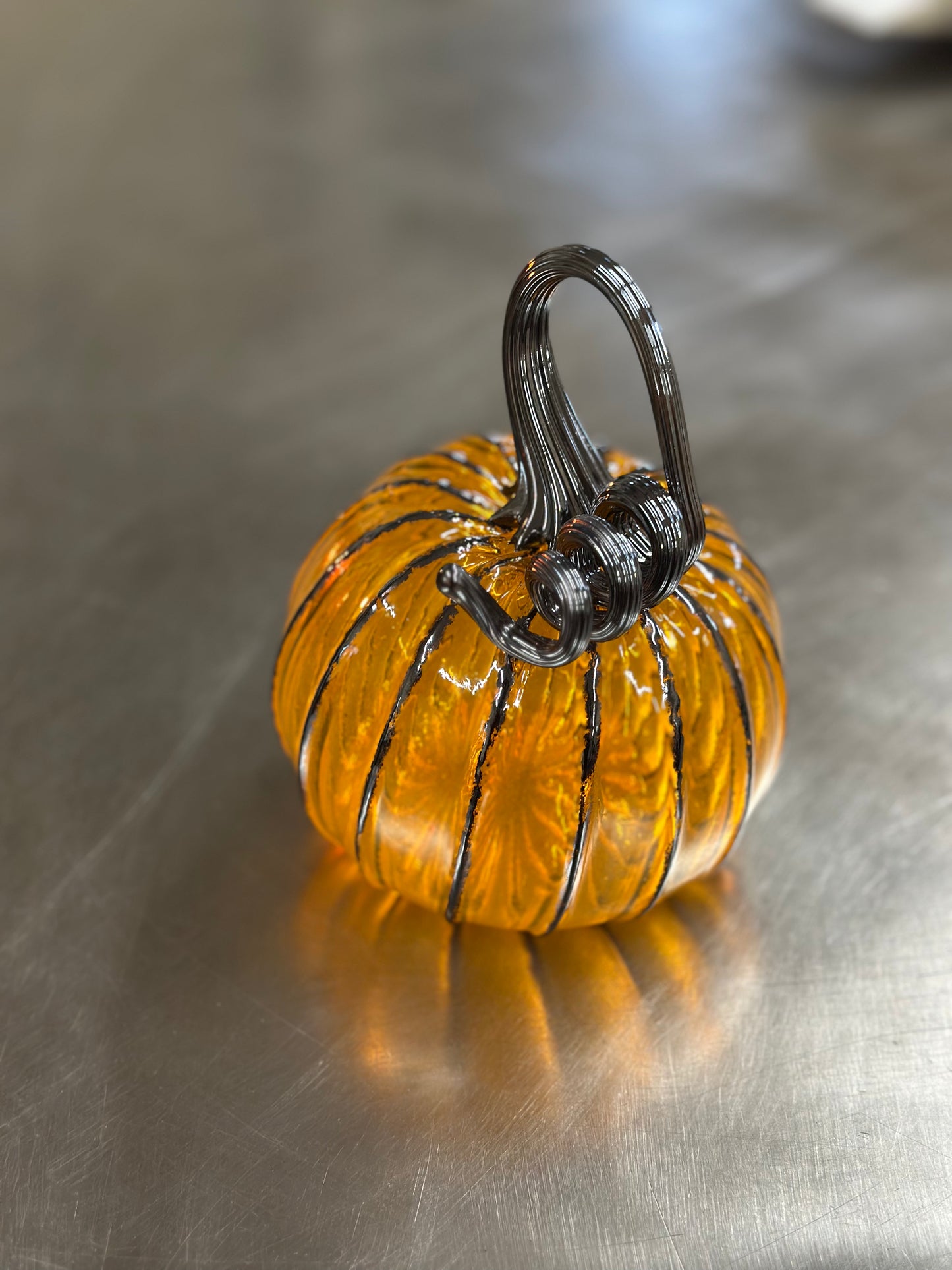 118 Gold and black glass pumpkin.