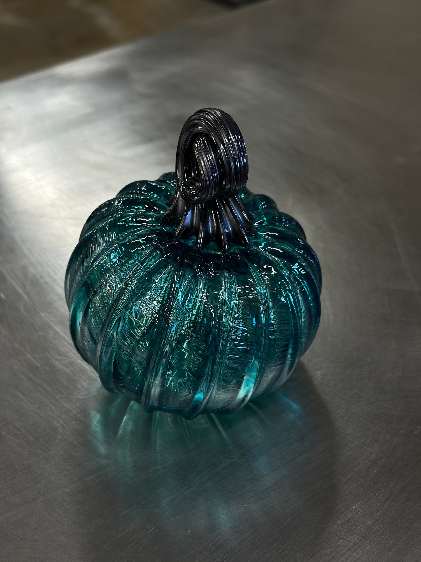 120 Capri blue and black glass pumpkin.