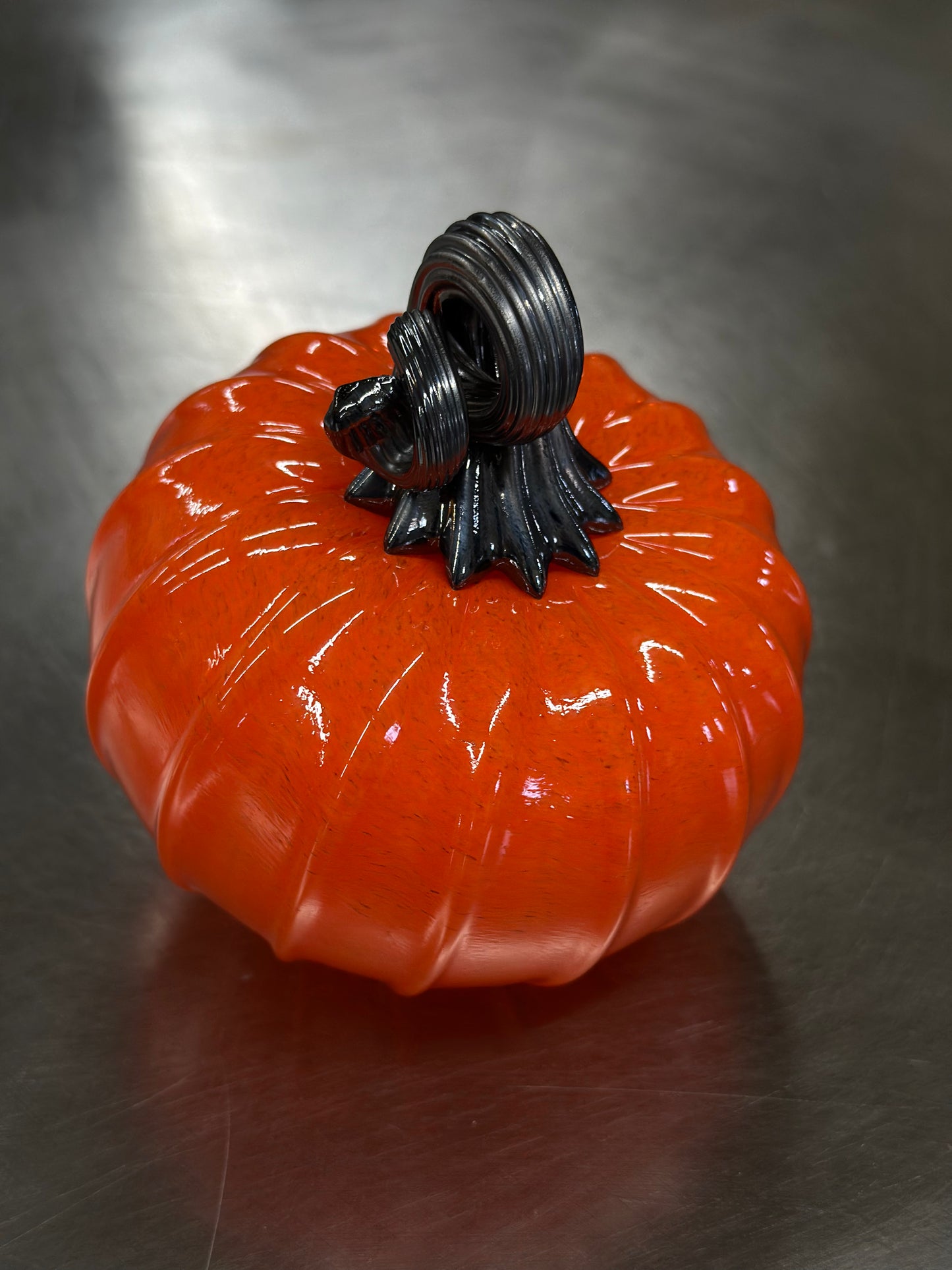 125 Bright orange and black glass pumpkin.