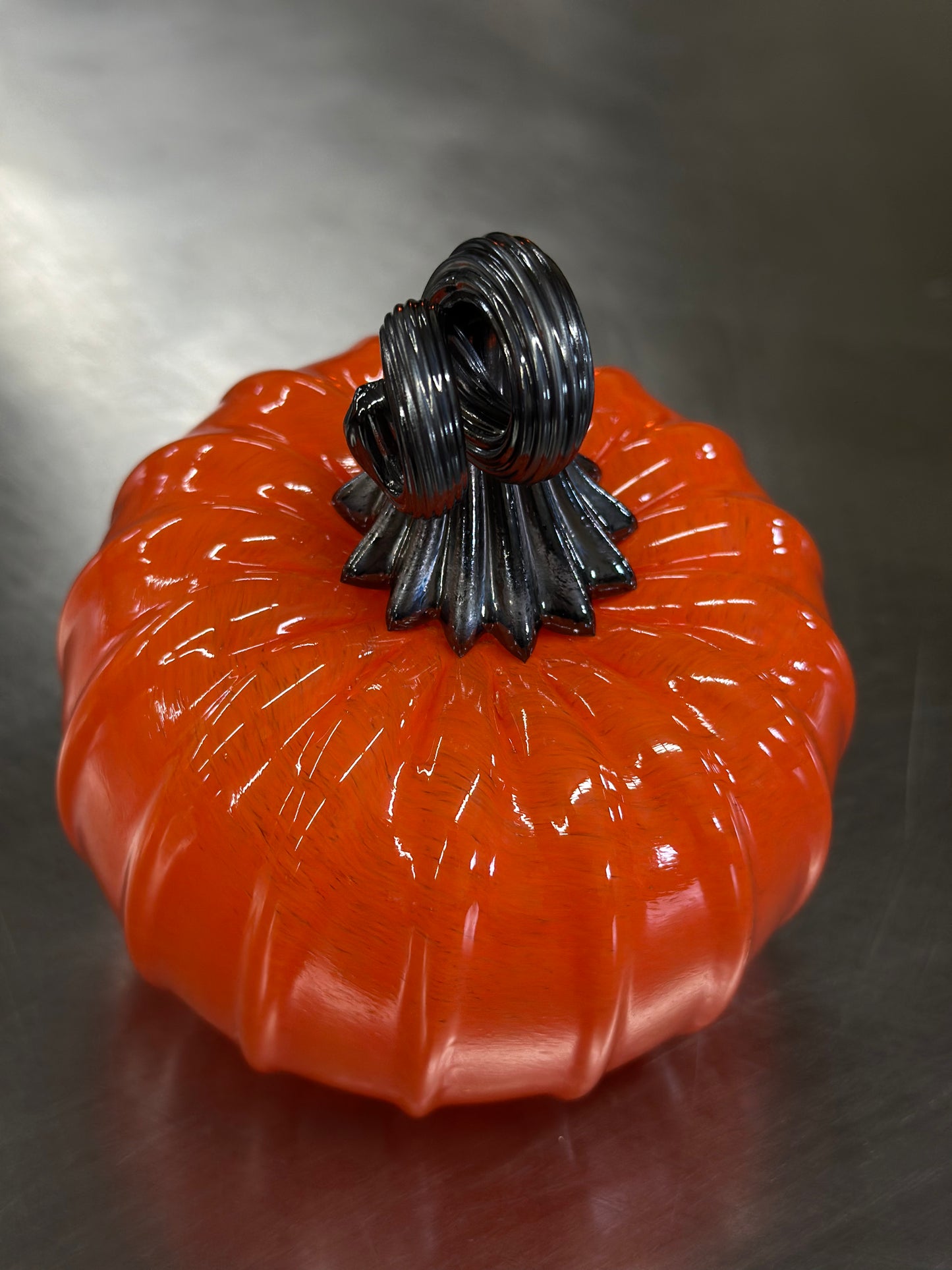 127 Bright orange and black glass pumpkin.