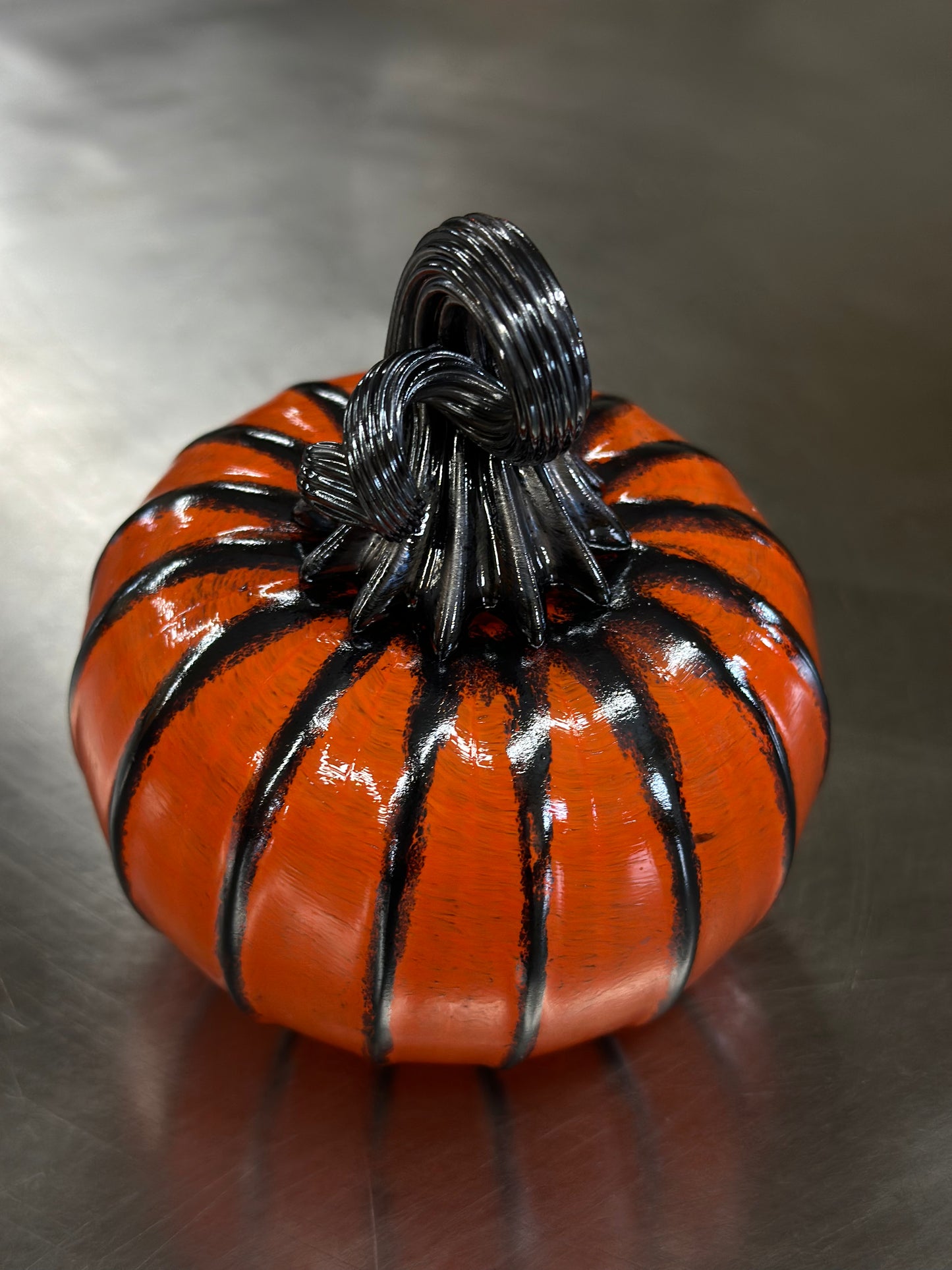 128 Bright orange and black glass pumpkin.
