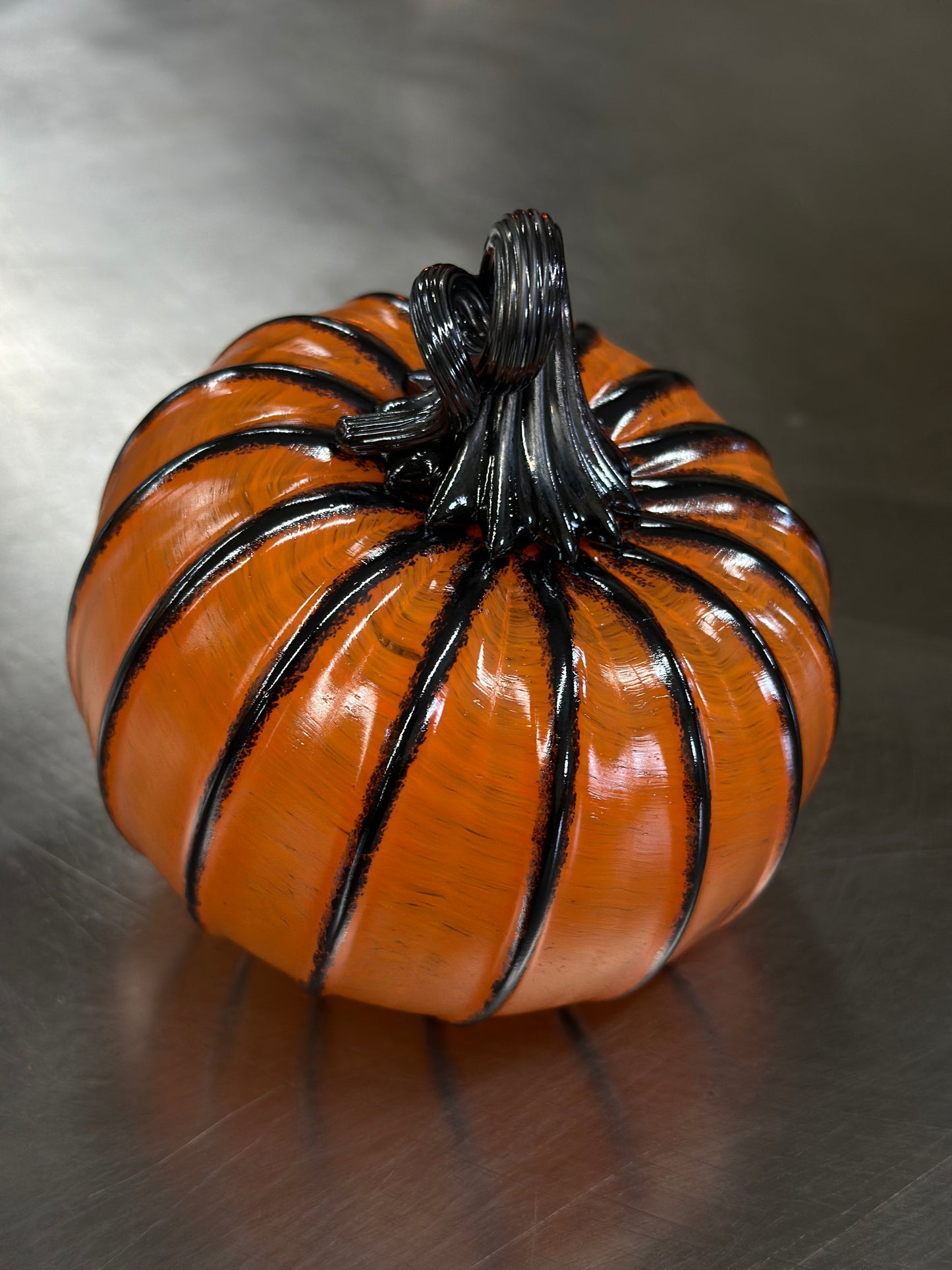 129 Bright orange and black glass pumpkin.