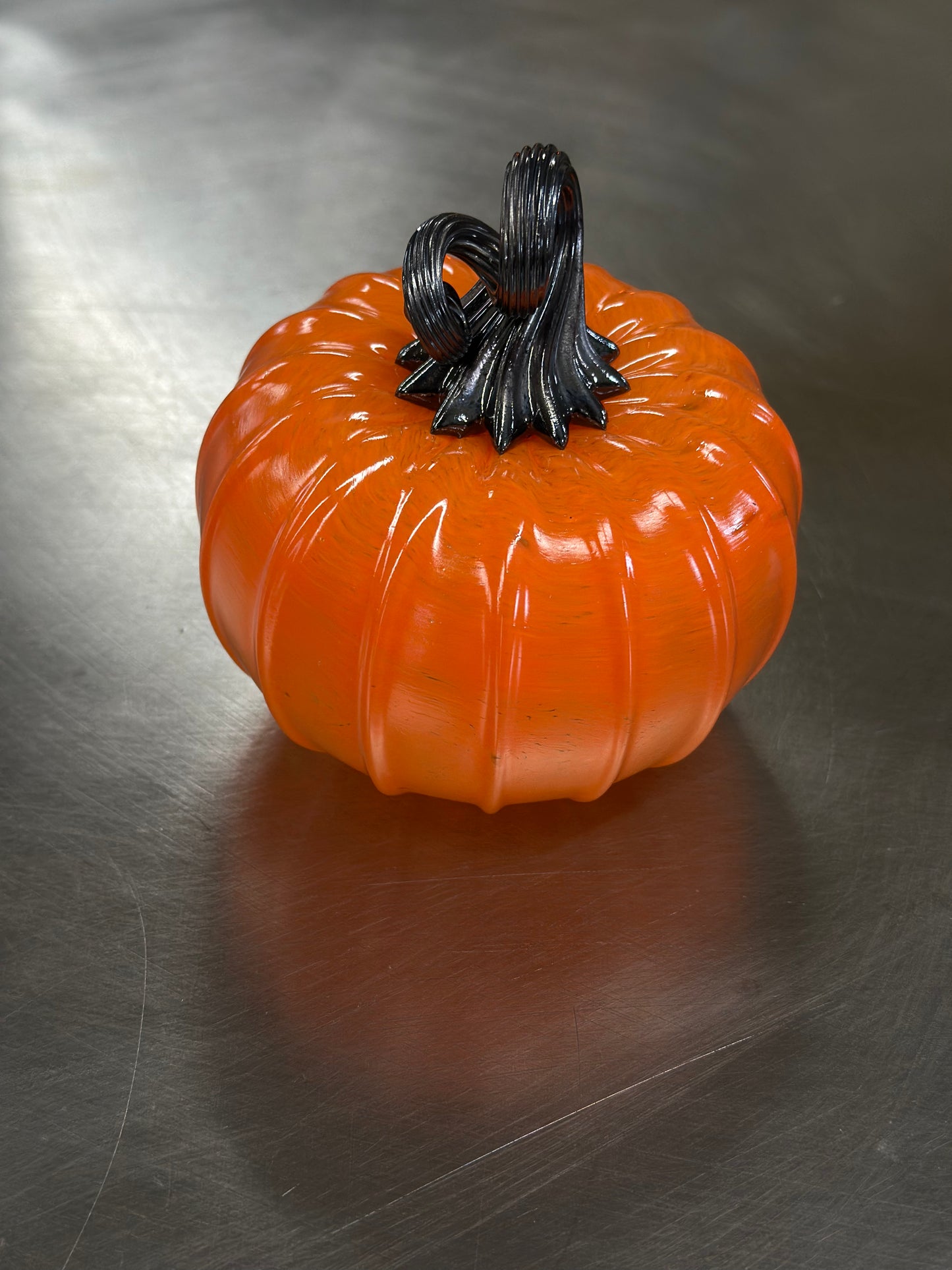 130 Bright orange and black glass pumpkin.